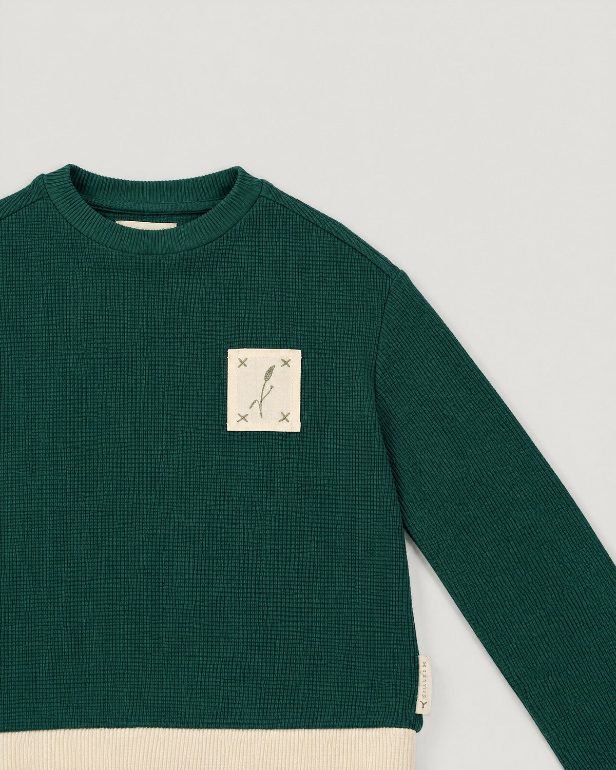 The Block Top in Juniper — name tape detail