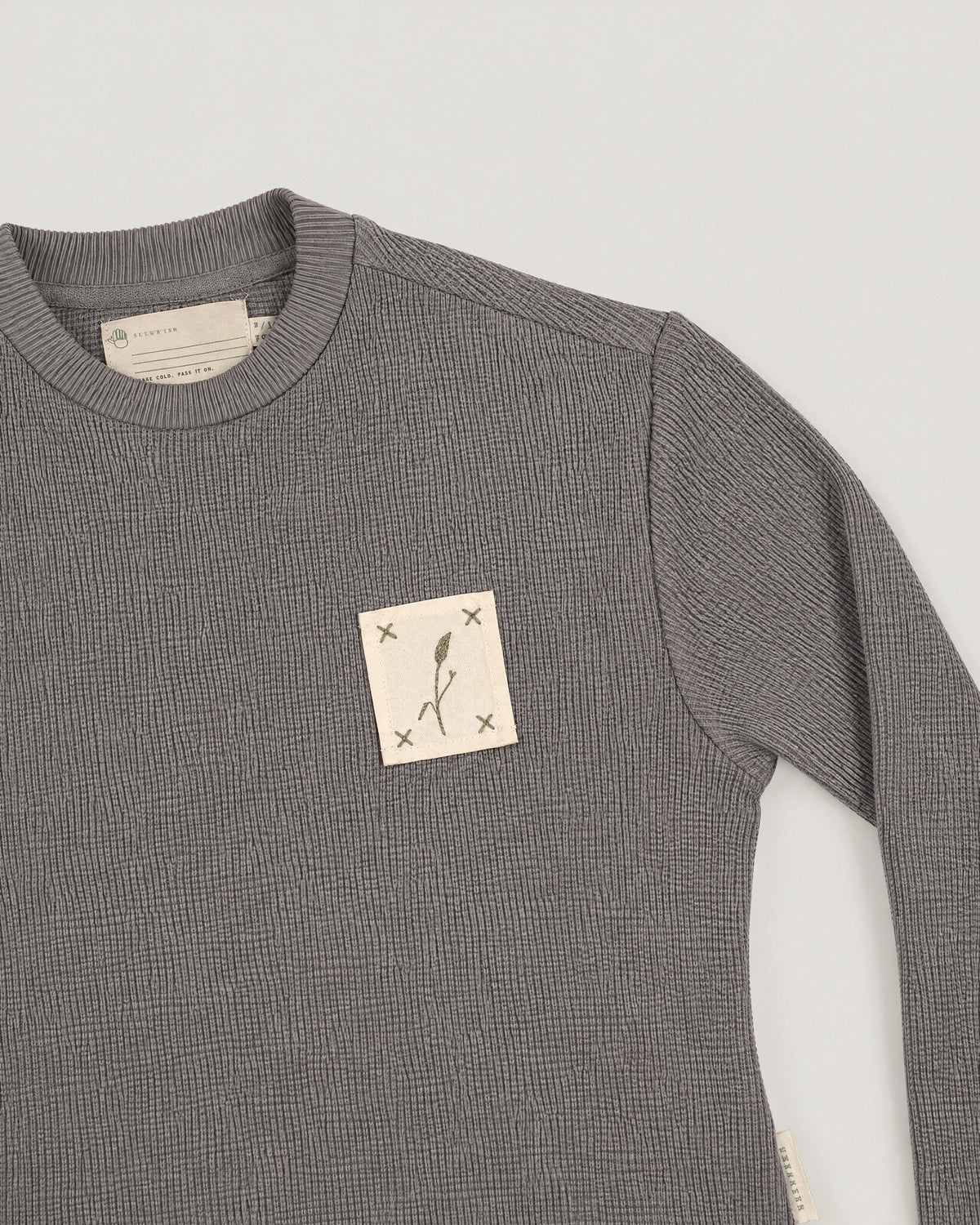 The Block Top in Pewter — name tape detail