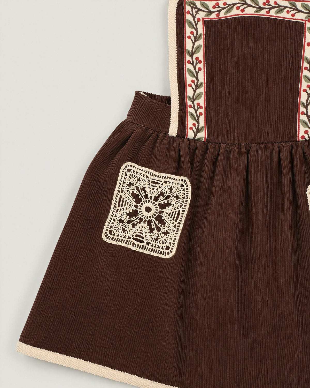 The Gift Pinafore in Bark — lace pocket and tape strap detail