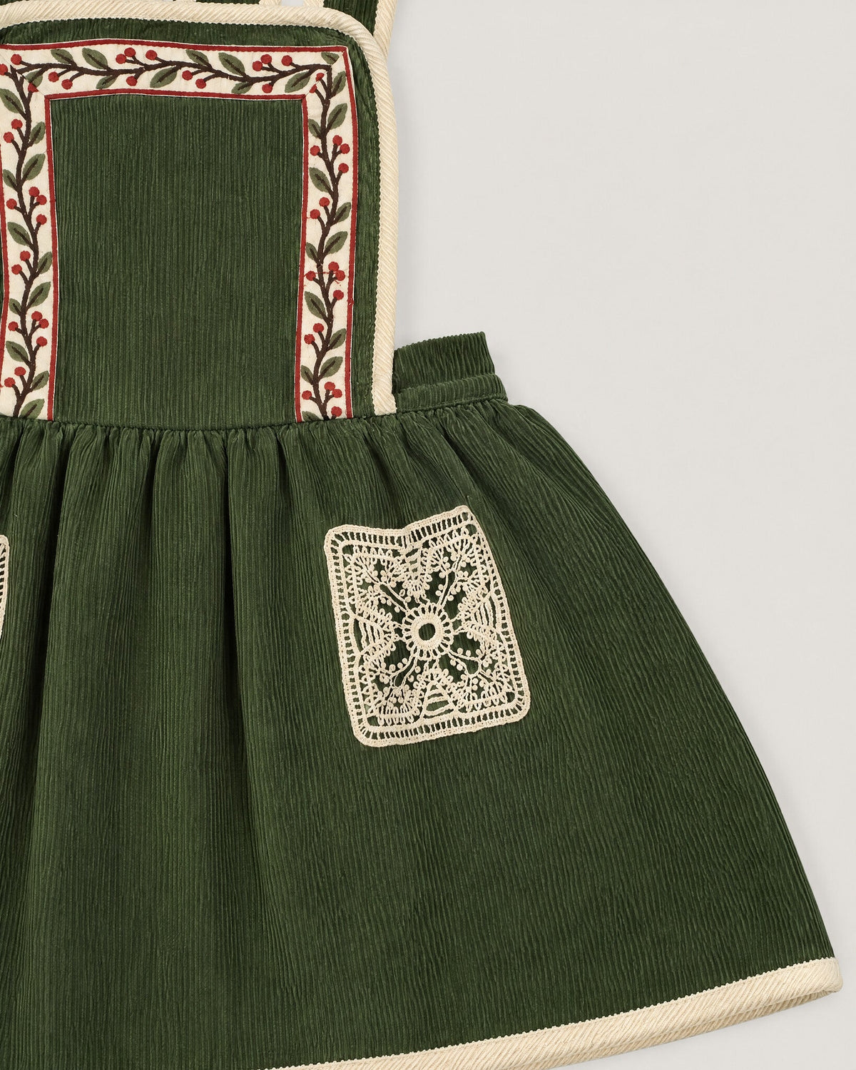 The Gift Pinafore in Moss — lace pocket and tape strap detail