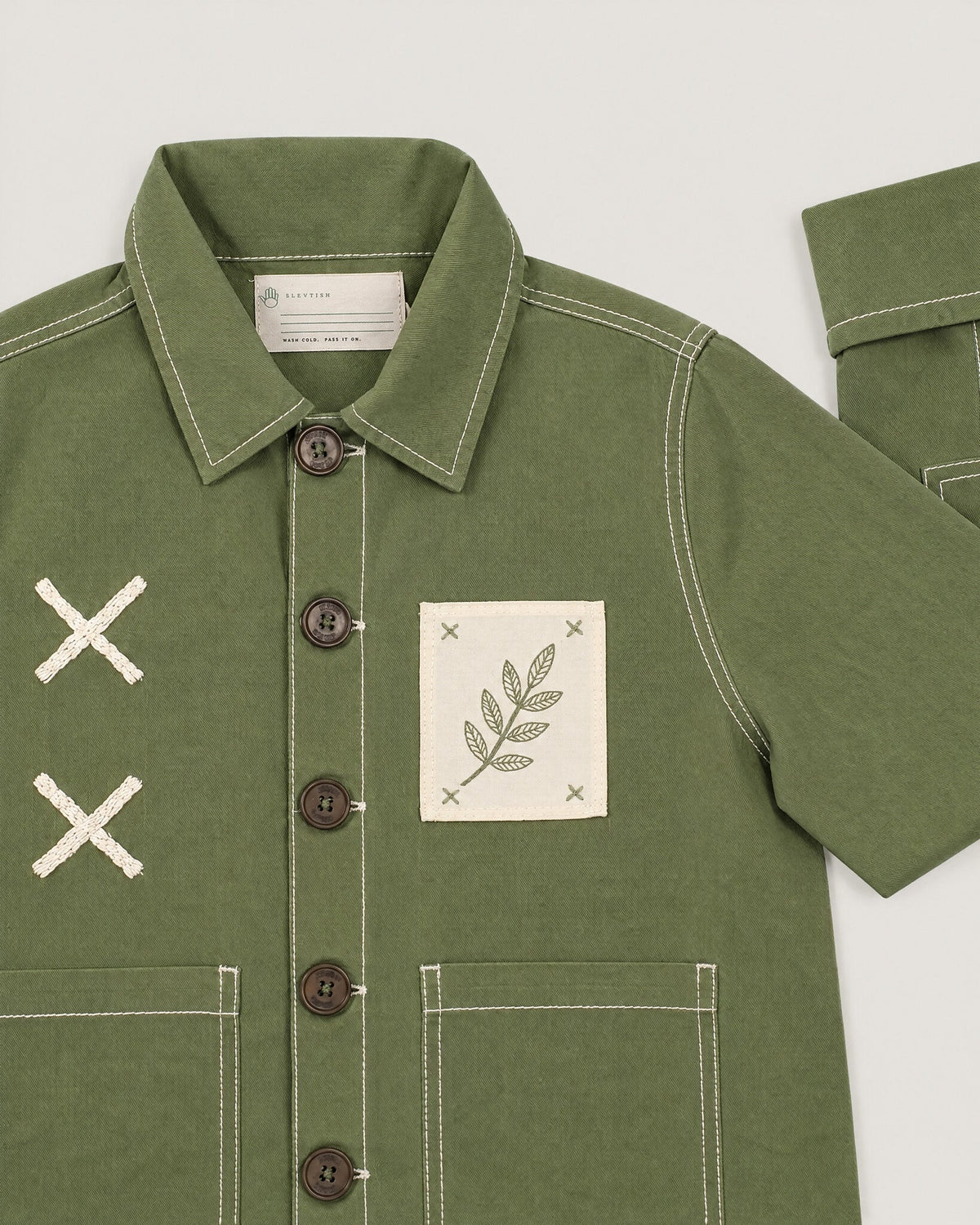 The Grid Overshirt in Moss — cross-stitch and pocket detail