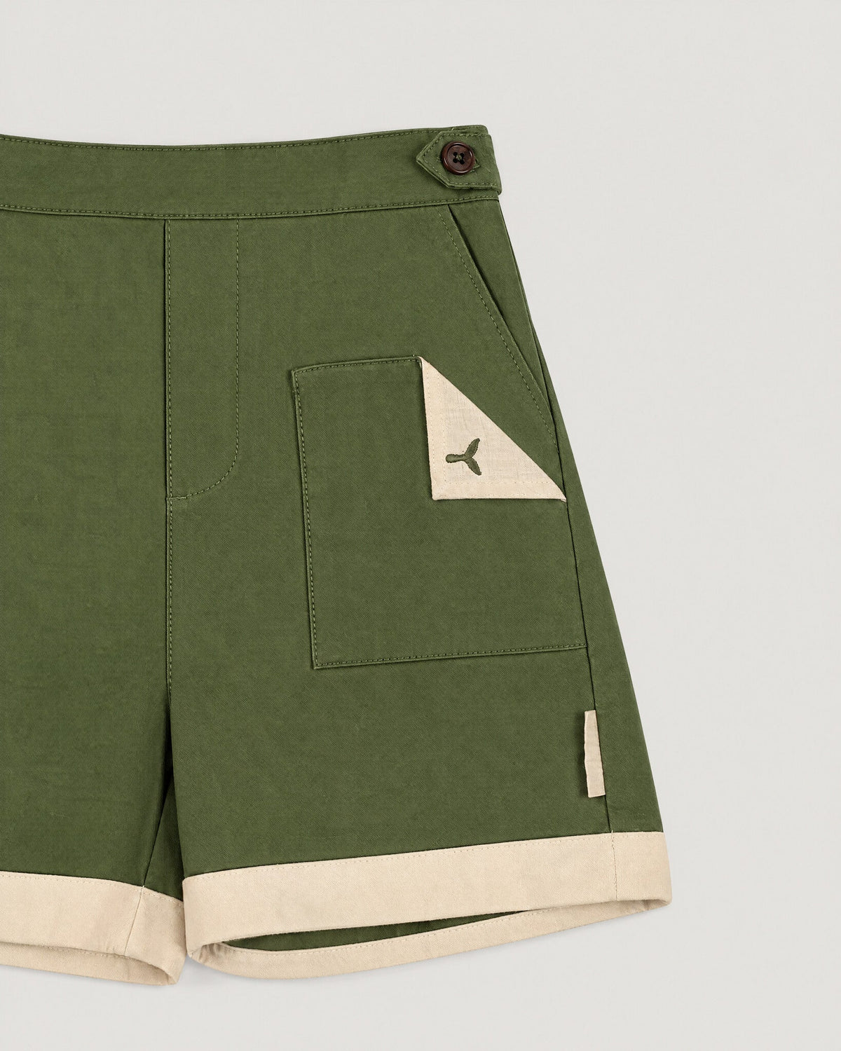 The Grid Shorts in Moss — pocket and name tape detail