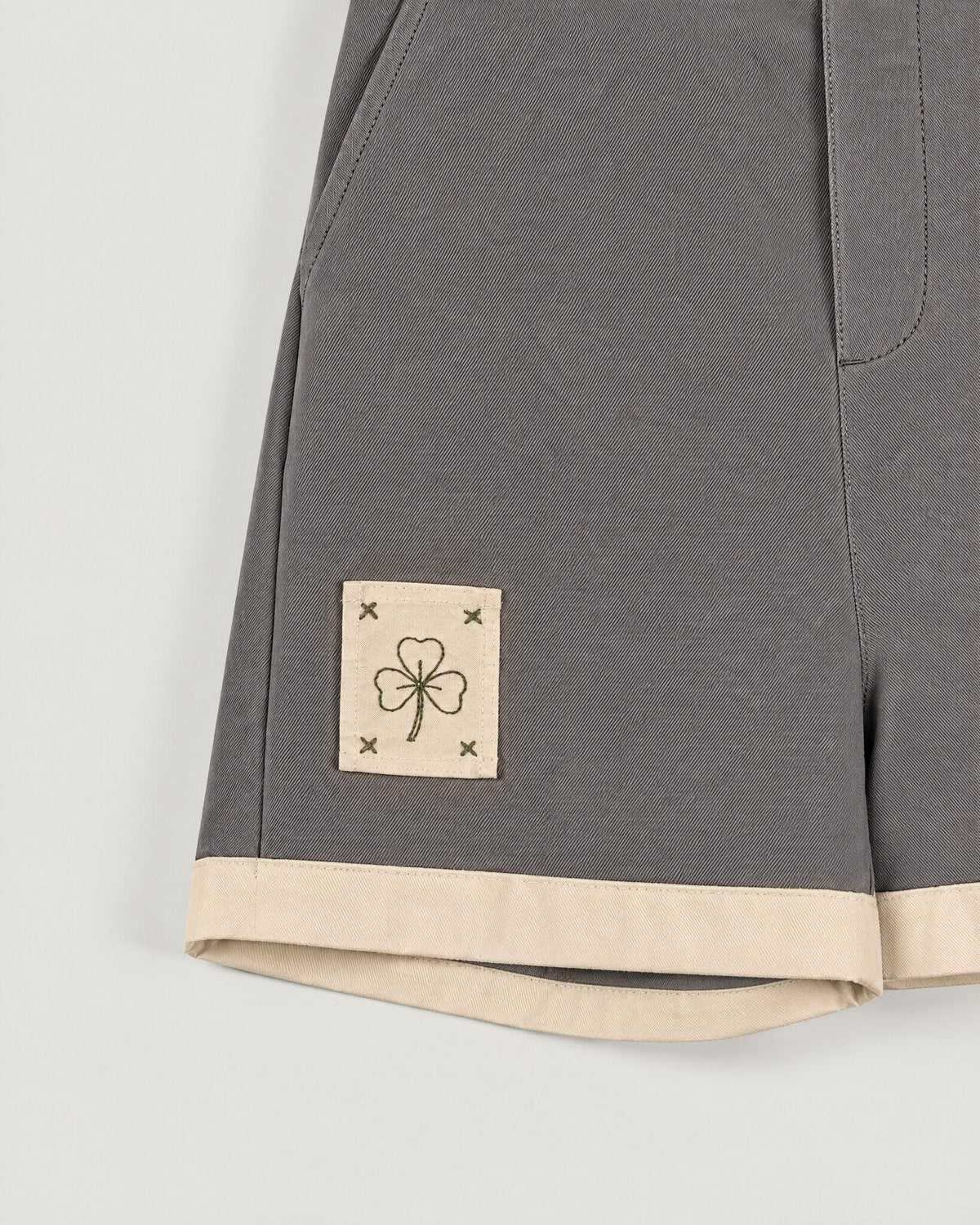 The Grid Shorts in Pewter — pocket and name tape detail