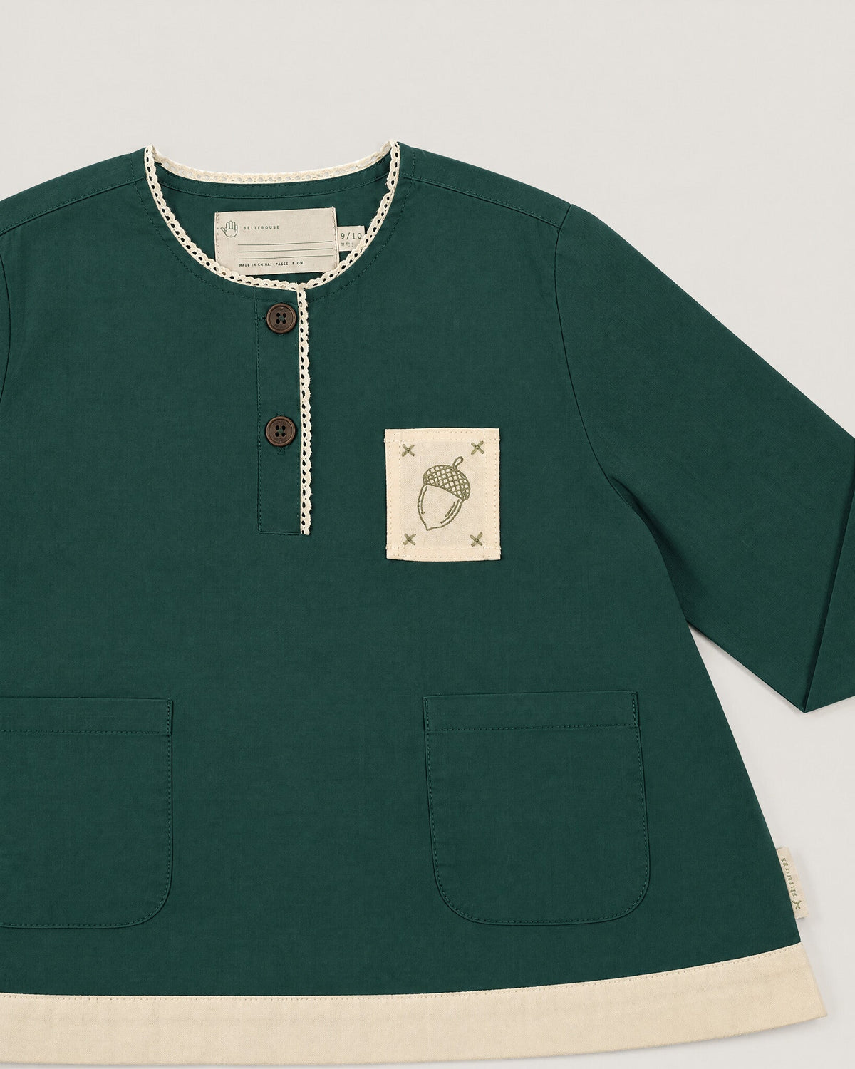 The Swing Top in Juniper — placket and acorn patch detail
